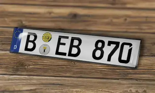 KFZ sticker-magnet on the wood background