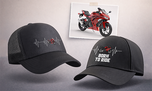 Two black caps with red motorcycle heartbeat design, right cap adds bold BORN TO RIDE text, photo of red bike behind