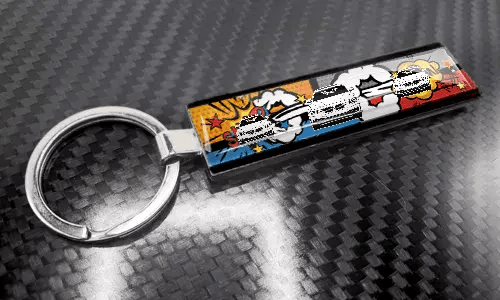 Comic-style XL slim keychain featuring a colorful license plate design on a carbon-textured surface