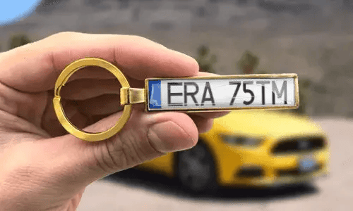 Custom gold keychain displays engraved license plate numbers