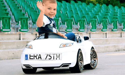 KFZ sticker-magnet on a kinds' electric car driving by a boy