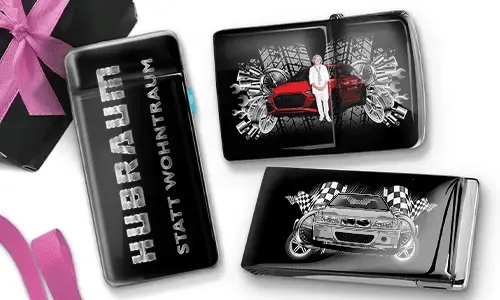 Three black and silver car-themed cigarette cases with dynamic graphics. One reads 