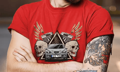 Red T-shirt with white SUV graphic, flanked by skulls and pistons, golden wings behind, worn by tattooed person