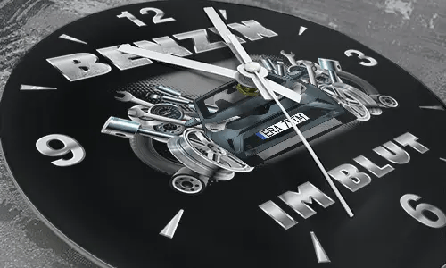Wall clock with black sports car, pistons and wrenches, BENZIN IM BLUT text on black background