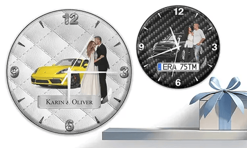 Two wall clocks with formal couple and sports cars: left with yellow car on quilted silver, right with black car on carbon background